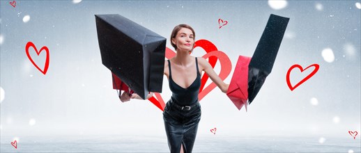 Happy woman jumping for joy with craft bags. Valentine's Day concept.