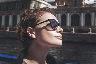 Portrait of a woman in St. Petersburg during a boat trip. Tourism concept
