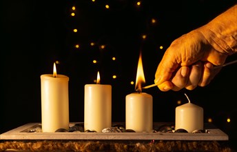Light the third Advent candle with a matchstick