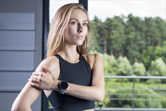Delightful woman posing with a smart watch. The concept of new technologies