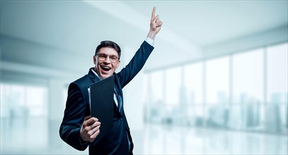 Man with a tablet in his hand screams with joy in the office. The concept of achieving success in business.