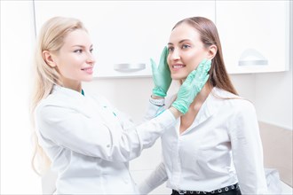 Two girls at the medical center. Consultation on rhinoplasty and blepharoplasty.