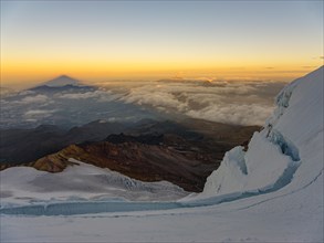 View from the glacier of the Cayambe volcano to its shadow at sunrise