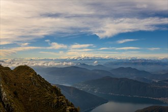 Aerial View over Beautiful Mountainscape with Snow Capped Mountain and Cloudscape and Lake Lugano in a Sunny Day From Monte Generoso
