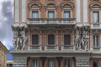 Four atlases on a historic house facade
