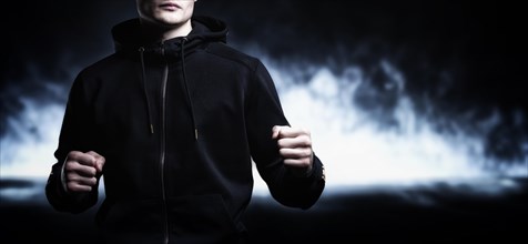 Young kickboxer posing in the studio. The concept of martial arts