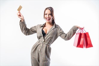 Sexy girl posing with a discount card and red bags. Concept Shopping on Black Friday. White background.