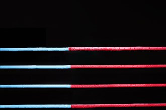 Boxing ring ropes on a black background. The concept of sports