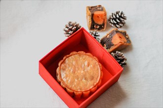 Mooncake presented in an opened red box
