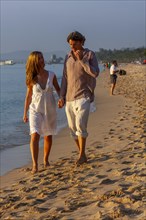 Young couple walking on the beach