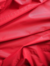 Rippled red polyester fabric texture background