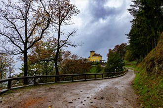 Mountain Road and a House on Monte Bre with Autumn Forest and Mountain in a Cloudy Day in Lugano