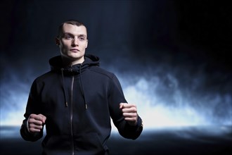 Young kickboxer posing in the studio. The concept of martial arts