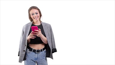 Portrait of a beautiful girl in a jacket with a mobile phone in hand. White background.