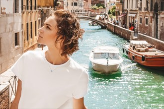 Portrait of a charming girl with a view of santa maria della salute. Travel and vacation concept.