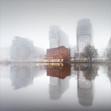 Minimalist long exposure of the former Ministry of the Interior on the Spree in thick morning fog in Moabit