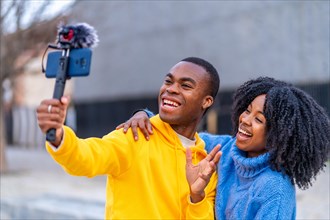 Young african people smiling during a live stream in the street