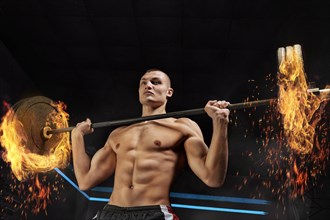 Portrait of an athlete who is lifting the barbell in the gym. The concept of sport and healthy lifestyle.