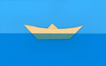 Paper boat in the sea