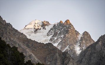 Glaciated mountain peak at sunset