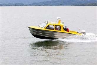 Water taxi travelling fast on Lake Chiemsee