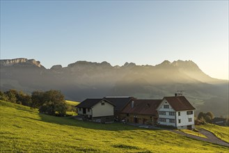 Lonely farmhouse in the Appenzell Alps in front of the Alpstein mountains with Saentis