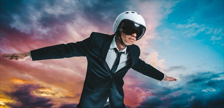 Portrait of a man in a suit and helmet. He is flying in the sky. Business concept.