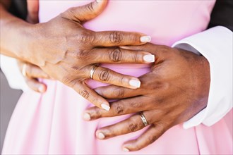 Black ethnic wedding couple with rings at a beautiful wedding