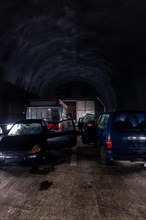 Dirty and Damaged Vehicles Inside a Mountain Road Tunnel in Switzerland
