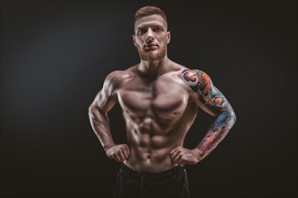 Young muscular guy posing in the studio. Fitness and nutrition concept.