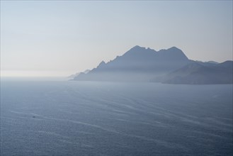 View of the misty Gulf of Porto with the Scandola nature reserve in the background