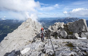 Climber on a via ferrata secured with a steel cable