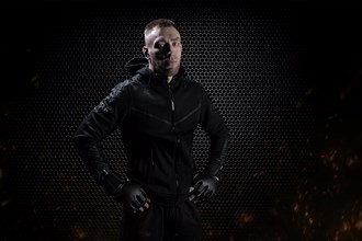 Mixed Martial Arts fighter posing on a metal grid background. Concept of mma