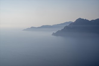 View of a Corsican coastal landscape in fog as texture or background