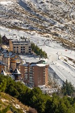 Aerial view of ski resort hotels and slopes with skiers