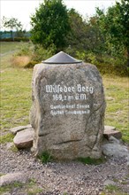 Summit stone on the Wilseder Berg with metal plate and height indication