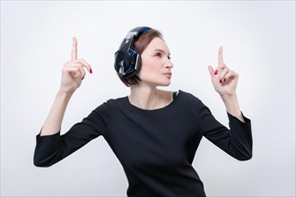 Portrait of a woman in professional headphones. White background. Dj concept.