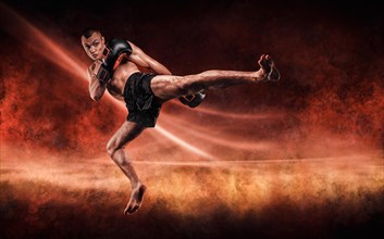 Professional kickboxer jumps with his knee extended. Fiery arena. Mixed martial arts. Sports concept