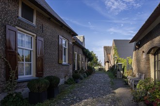 Street with brick houses and cobblestones in the small town of Bronkhorst