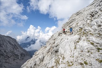 Mountaineer on a steep rocky path