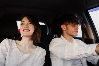 Young beautiful happy couple in love went on a trip by car