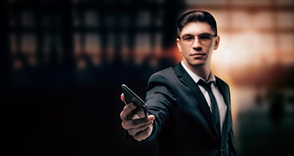 Man in a suit holds out a mobile phone. Airport assistance concept. Emergency contact with a tour operator. Insurance.