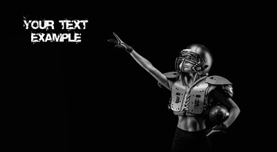 Image of a girl in the uniform of an American football team player. She points her finger at the ad copy. Black background. Sports concept. Shoulders pads.