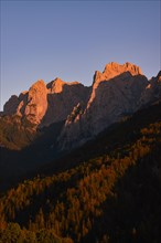 The last rays of sunlight illuminate the peaks of the Wilder Kaiser
