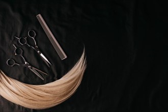 Natural hair of different colors with scissors and comb. concept of hair care and hairdressing services