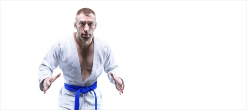 Sportsman in a kimono with a blue belt. White background. The concept of karate and judo competitions.