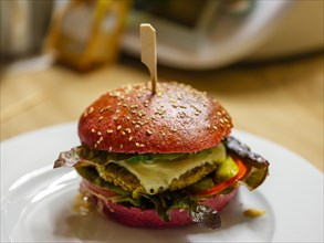 Delicious veggie burger in a beetroot bun