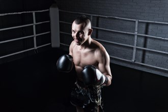 Portrait of kickboxer occupying an opponent in the ring. Sports concept