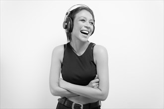 Portrait of a laughing woman in headphones. Musical accessories concept.