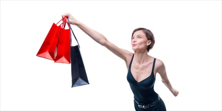 Portrait of a beautiful woman with packages. She enthusiastically rushes shopping. Shopaholic concept. Shopping centers. Sales